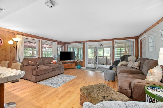 living room featuring wooden walls and light hardwood / wood-style flooring