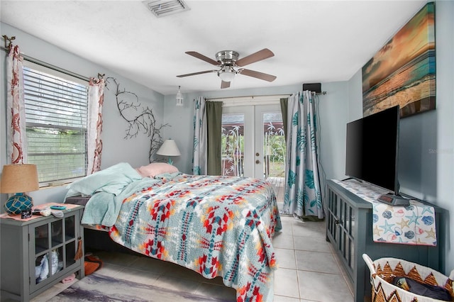 bedroom with ceiling fan, light tile patterned flooring, multiple windows, and access to exterior