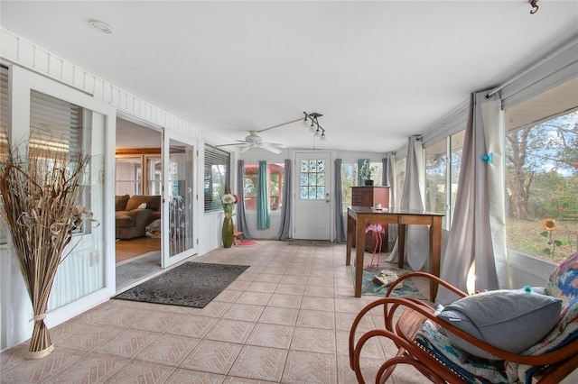 sunroom / solarium featuring ceiling fan