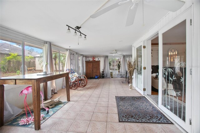 sunroom featuring ceiling fan