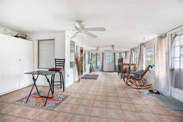 sunroom featuring ceiling fan