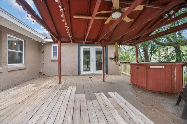 deck with french doors and ceiling fan