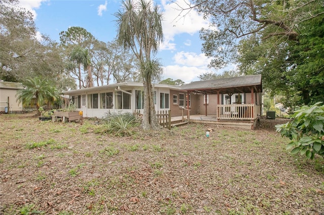 rear view of house with a sunroom and central AC unit