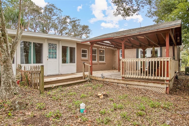 rear view of house featuring a deck