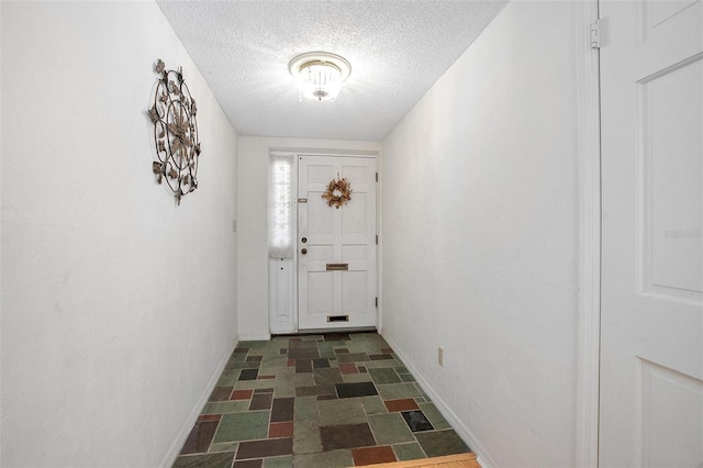 doorway with a textured ceiling