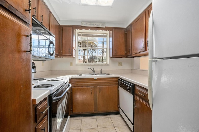 kitchen featuring sink, white appliances, and light tile patterned floors