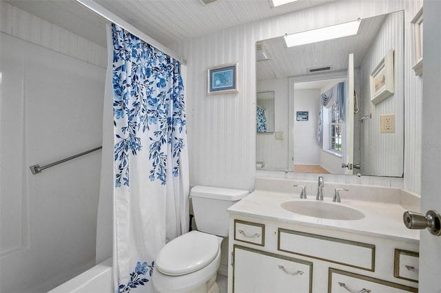 full bathroom with vanity, toilet, and shower / bath combo with shower curtain