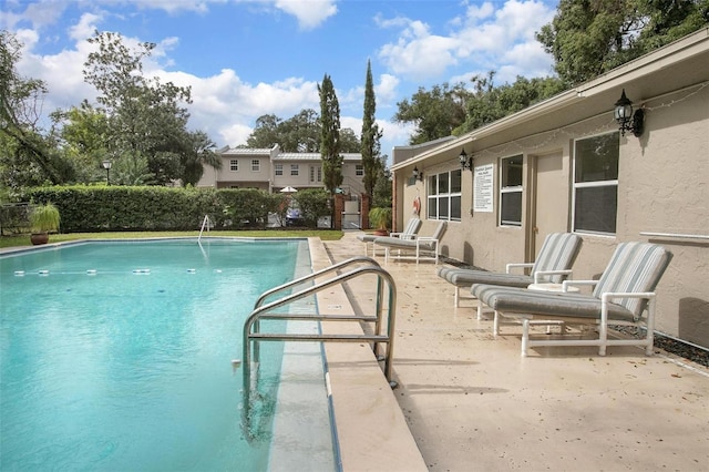 view of swimming pool with a patio