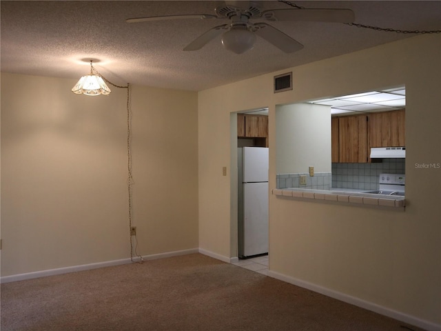 interior space with ceiling fan and a textured ceiling