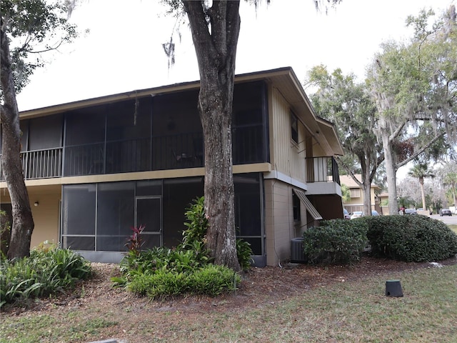 view of side of property featuring central air condition unit