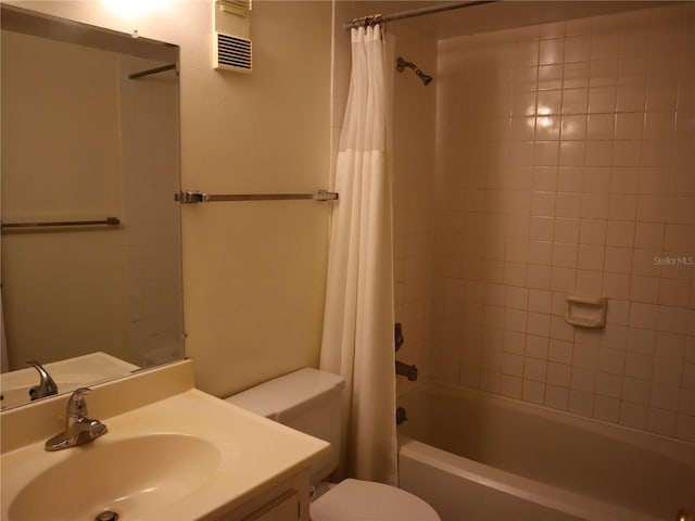 full bathroom featuring shower / bath combo with shower curtain, toilet, and vanity