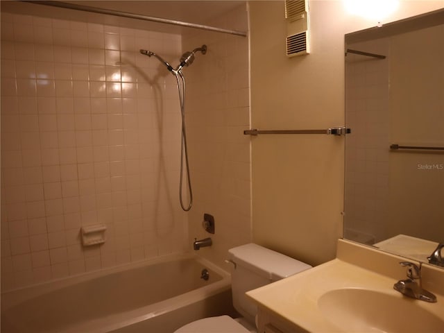 full bathroom with sink, toilet, and tiled shower / bath