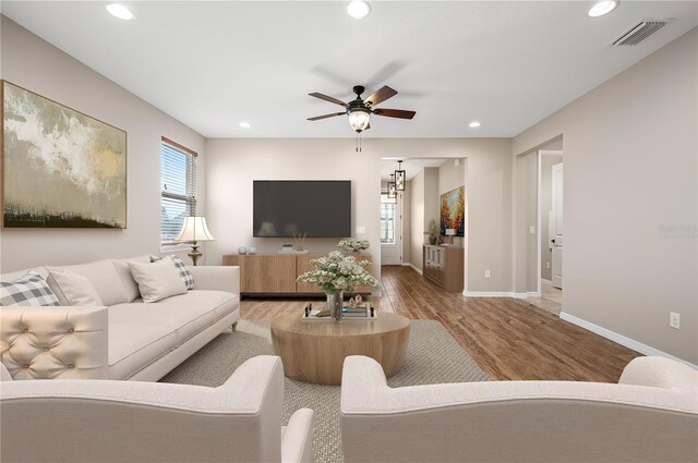 living room with hardwood / wood-style flooring and ceiling fan