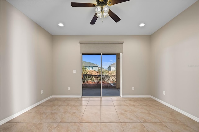 tiled spare room with ceiling fan