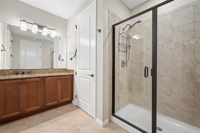 bathroom featuring an enclosed shower, vanity, and tile patterned floors