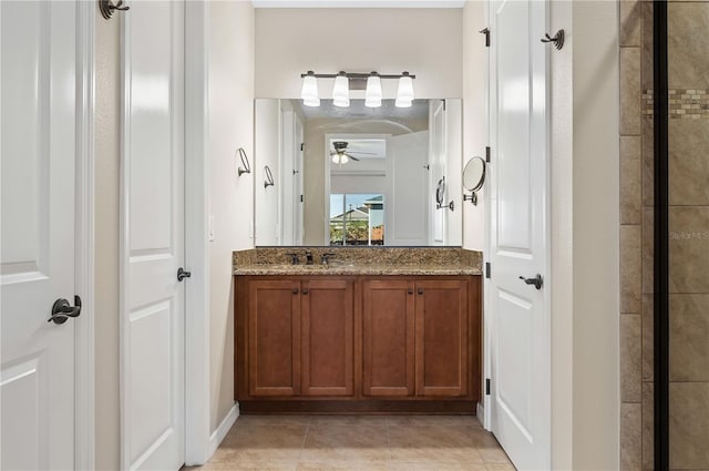 bathroom featuring ceiling fan, vanity, and tile patterned flooring