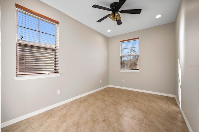 tiled spare room with ceiling fan