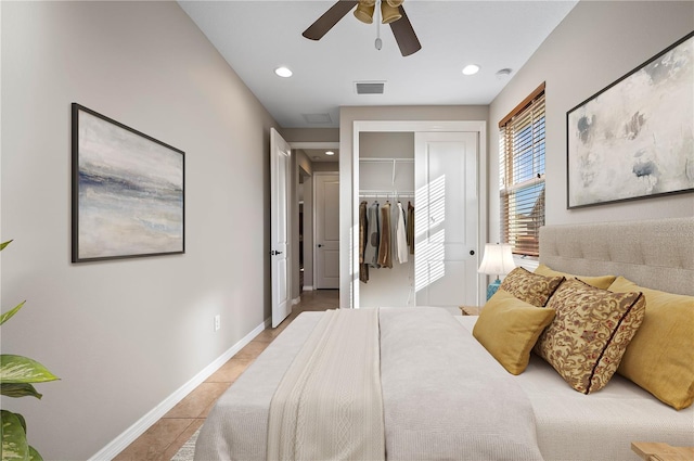 bedroom featuring ceiling fan, light tile patterned floors, and a closet