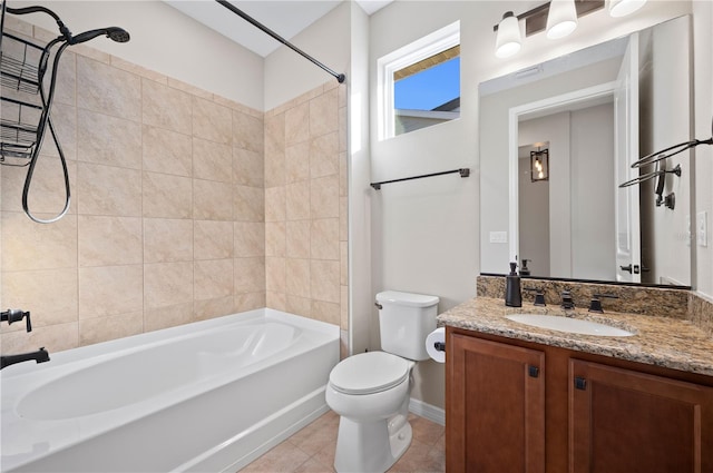 full bathroom featuring toilet, vanity, tiled shower / bath, and tile patterned flooring