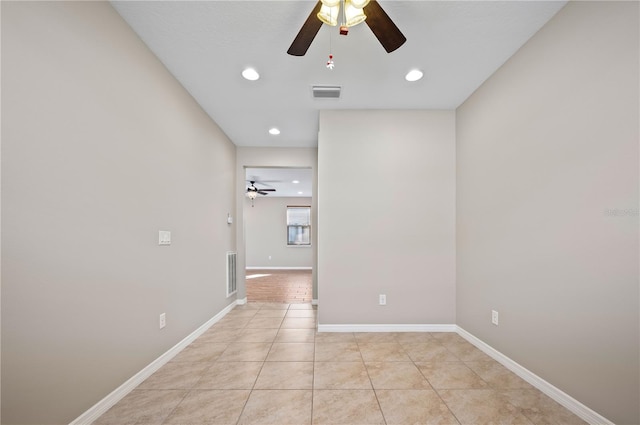 unfurnished room with ceiling fan and light tile patterned flooring