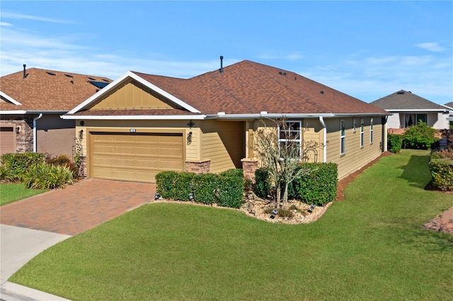 view of front of house with a front yard and a garage