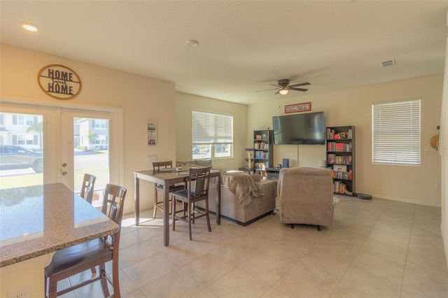 living room featuring ceiling fan, french doors, and light tile patterned floors