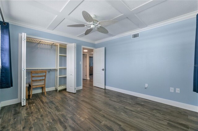 unfurnished bedroom with dark wood-type flooring, a closet, ornamental molding, ceiling fan, and coffered ceiling