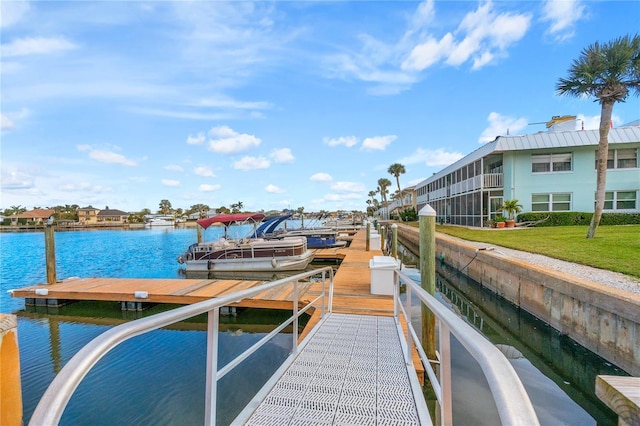 view of dock featuring a water view and a yard