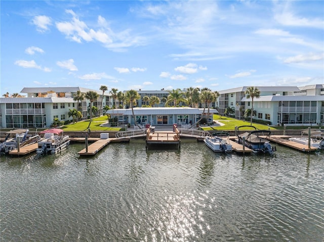 view of dock with a yard and a water view