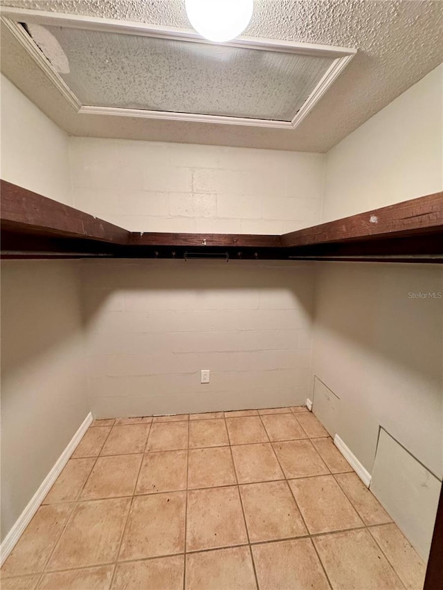 spacious closet with light tile patterned floors