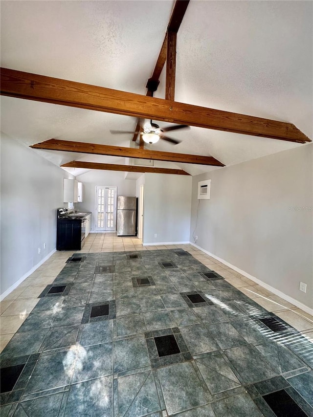 unfurnished living room featuring ceiling fan, french doors, vaulted ceiling with beams, an AC wall unit, and a textured ceiling