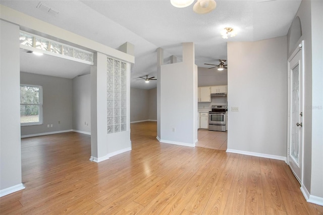 unfurnished living room with lofted ceiling and light hardwood / wood-style floors