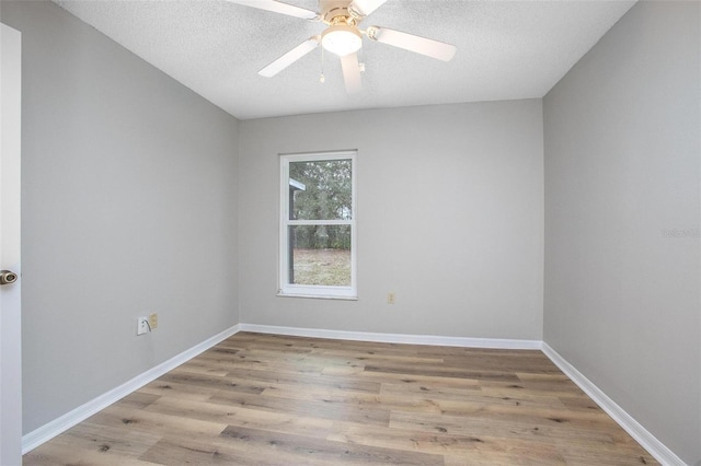 empty room featuring a textured ceiling, ceiling fan, and light hardwood / wood-style floors