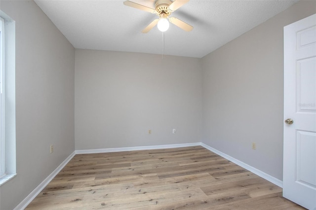 unfurnished room with light wood-type flooring, ceiling fan, and a textured ceiling