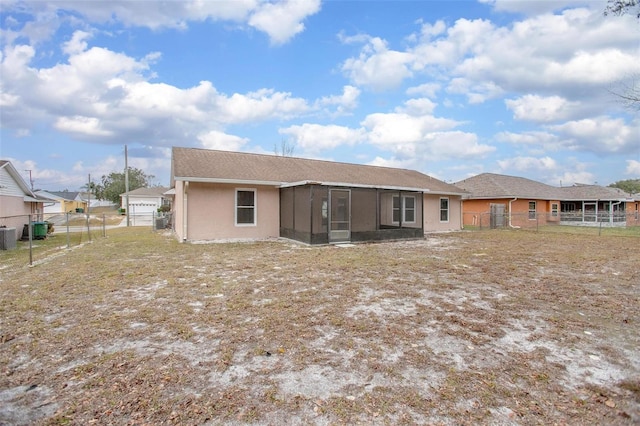 rear view of house featuring cooling unit and a sunroom