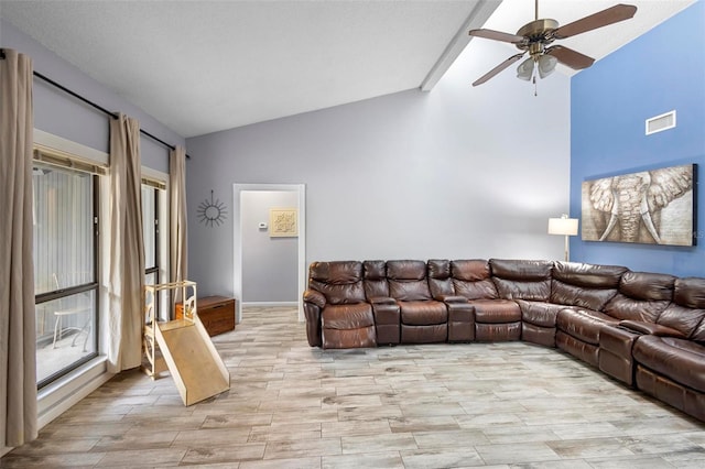 unfurnished living room with ceiling fan and vaulted ceiling