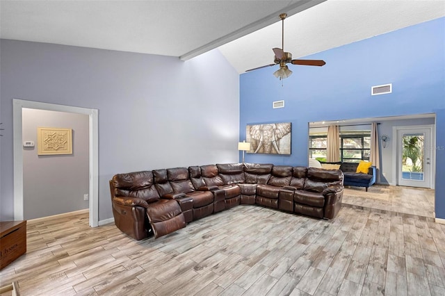 living room featuring ceiling fan, light wood-type flooring, and vaulted ceiling