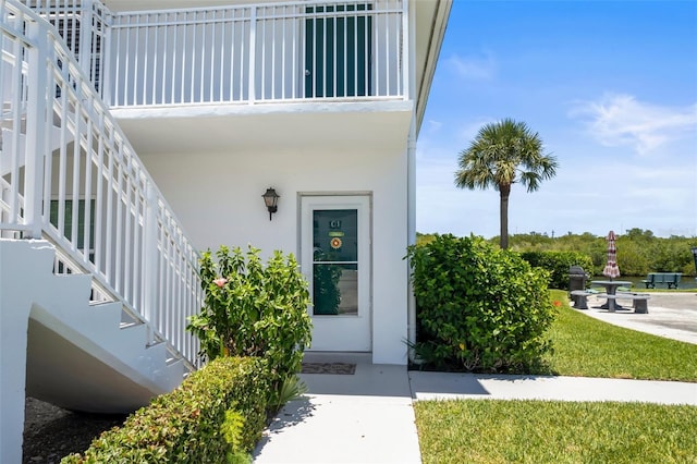 entrance to property with a lawn