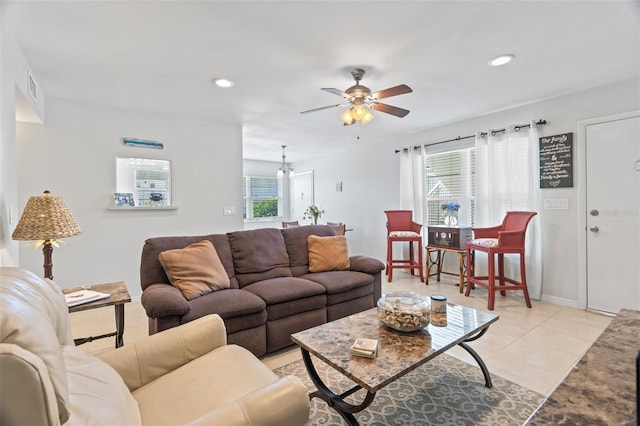 tiled living room with ceiling fan