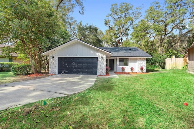 ranch-style home with a front yard and a garage