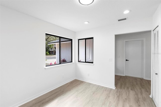 spare room featuring light wood-type flooring