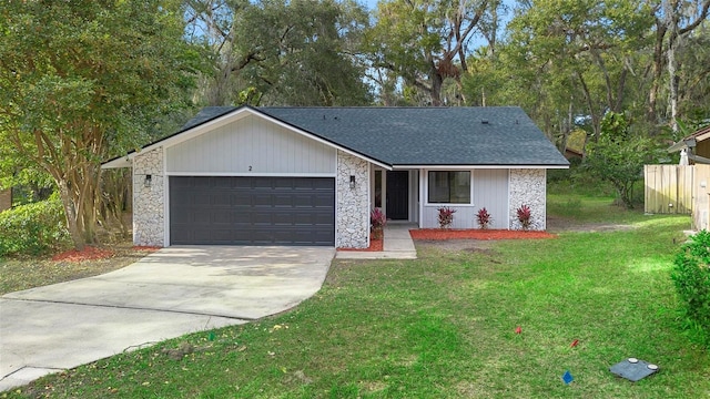 single story home with a garage and a front lawn