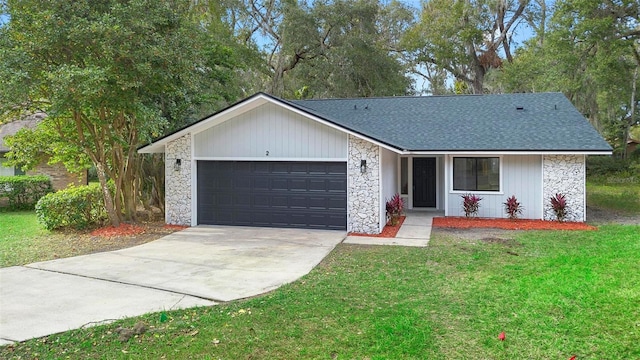 single story home featuring a garage and a front lawn