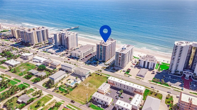 bird's eye view featuring a water view and a beach view