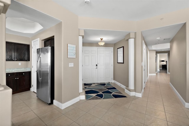 foyer entrance featuring light tile patterned flooring