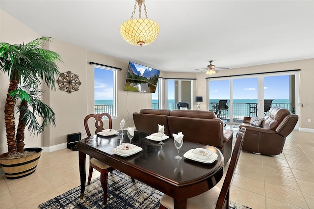 tiled dining area featuring ceiling fan