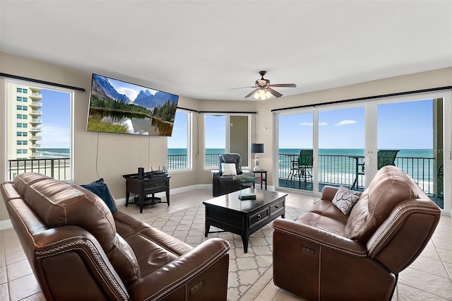 tiled living room with ceiling fan