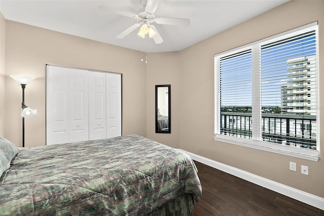 bedroom with ceiling fan, a closet, and dark wood-type flooring