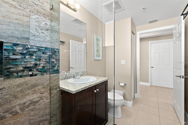 bathroom featuring tile patterned floors, vanity, and toilet