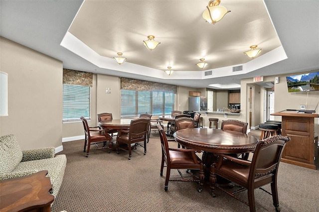 carpeted dining area featuring a tray ceiling and billiards